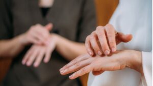 Hands demonstrating EFT tapping points on wrist and hand meridians, showing evidence-informed guide to emotional freedom technique acupressure locations