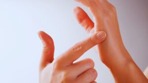 Hands demonstrating proper EFT tapping technique on fingers, showing step-by-step guide for emotional freedom technique tapping mechanics and finger points